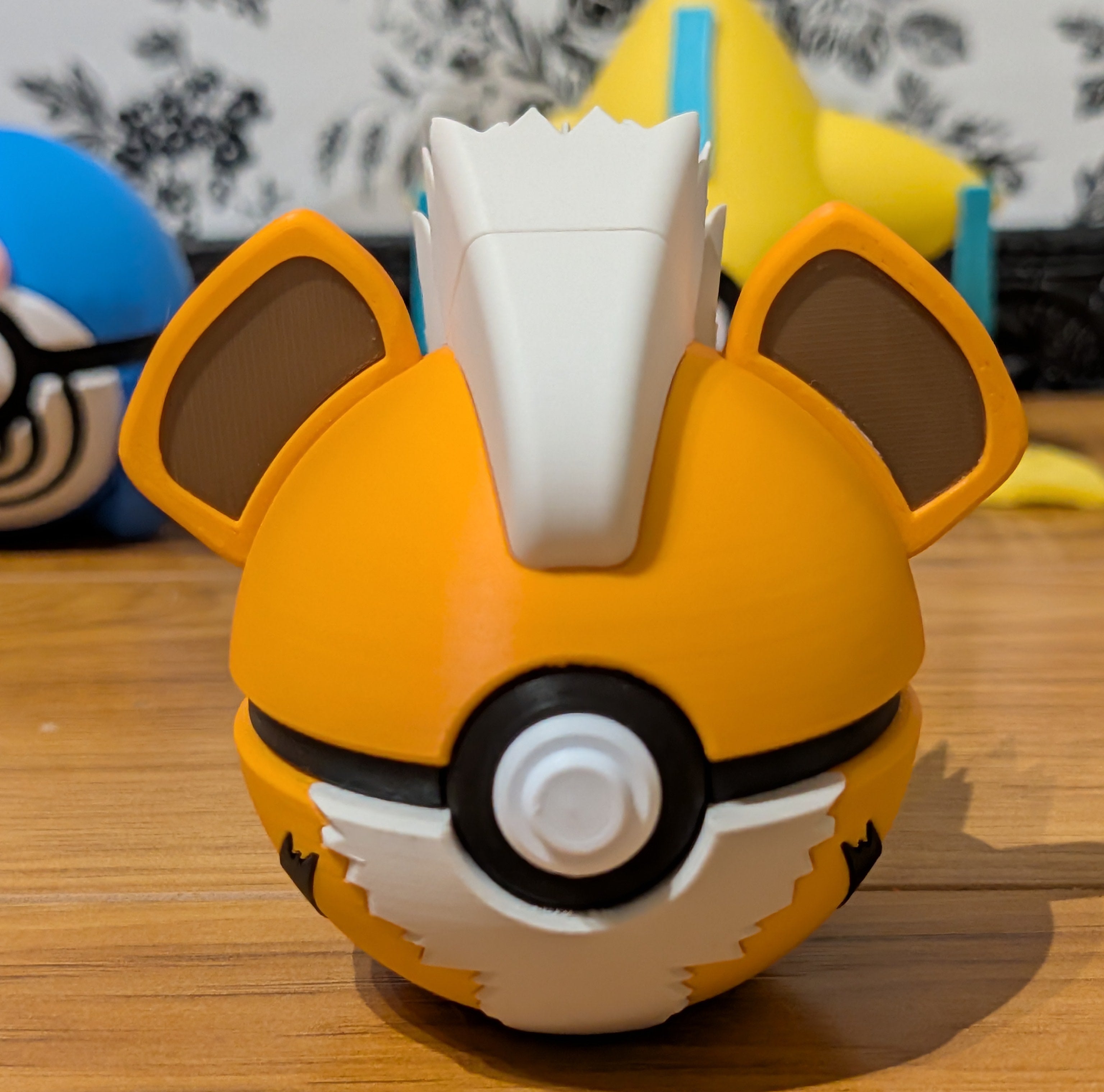 Toy figure with a round body, orange top, and white bottom 