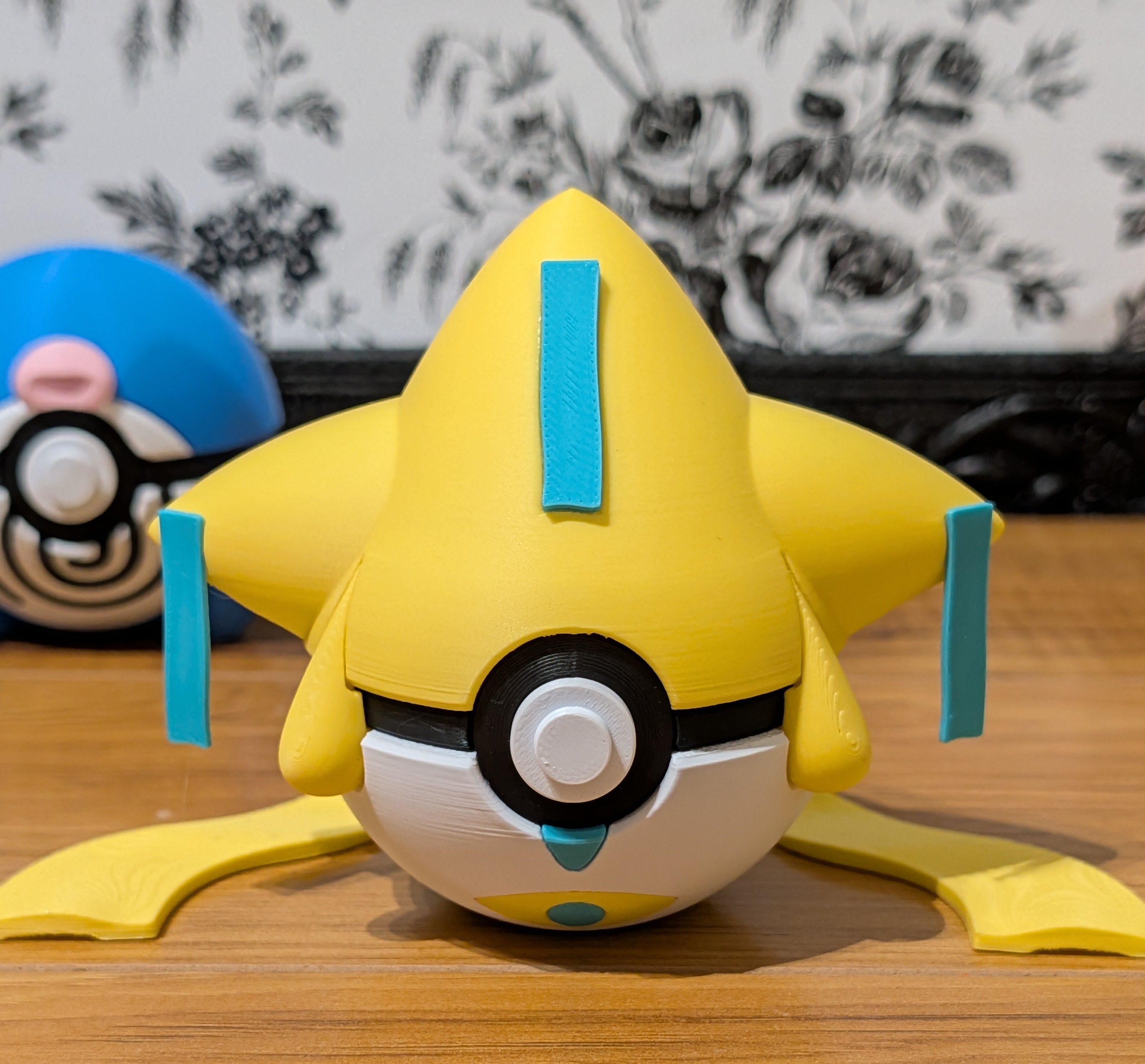 Yellow click toy with a round body and blue accents